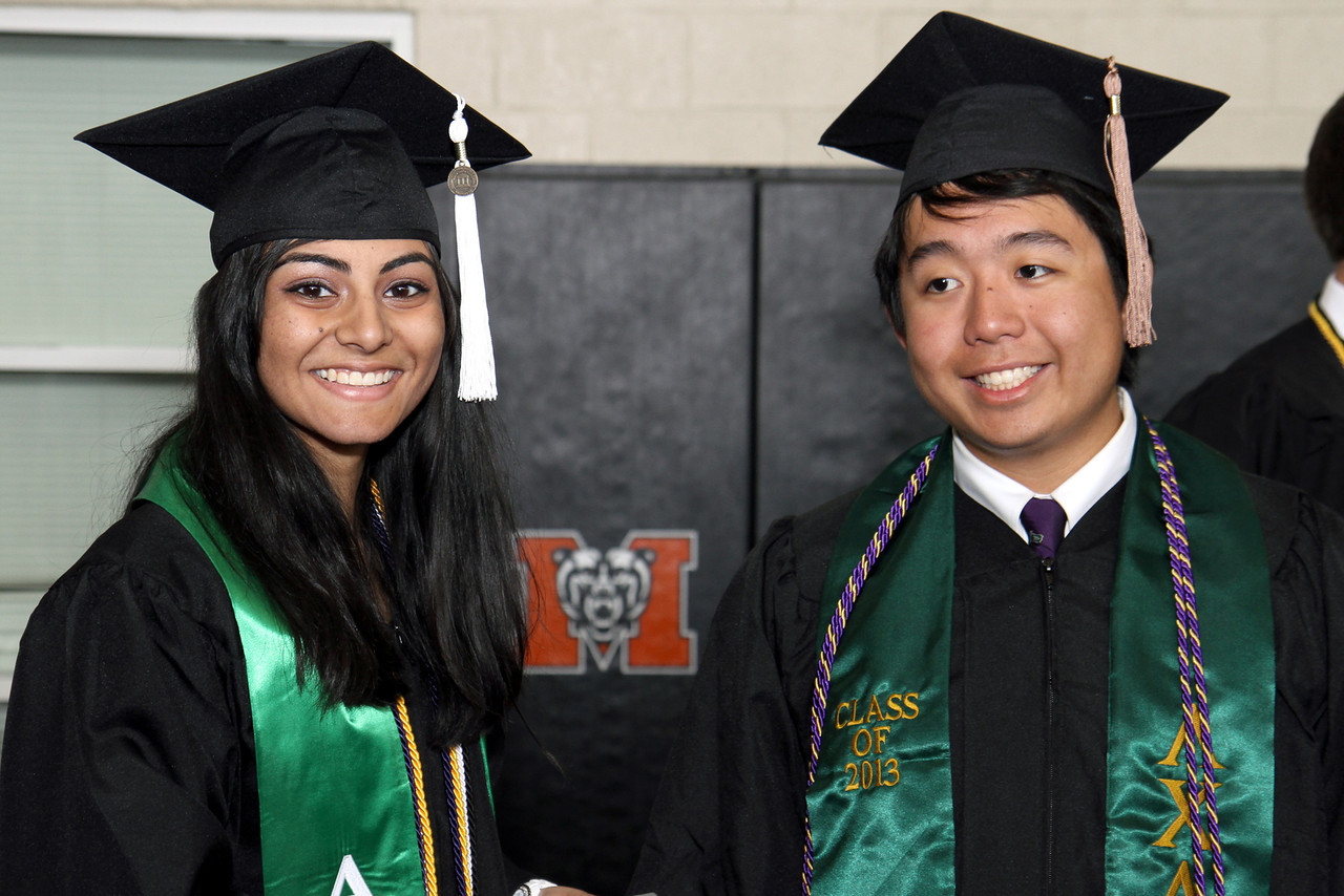 Two graduates pose for the camera