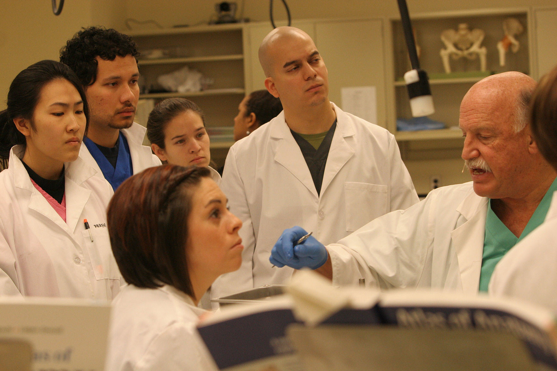 Students listen to a faculty member teaching in a lab